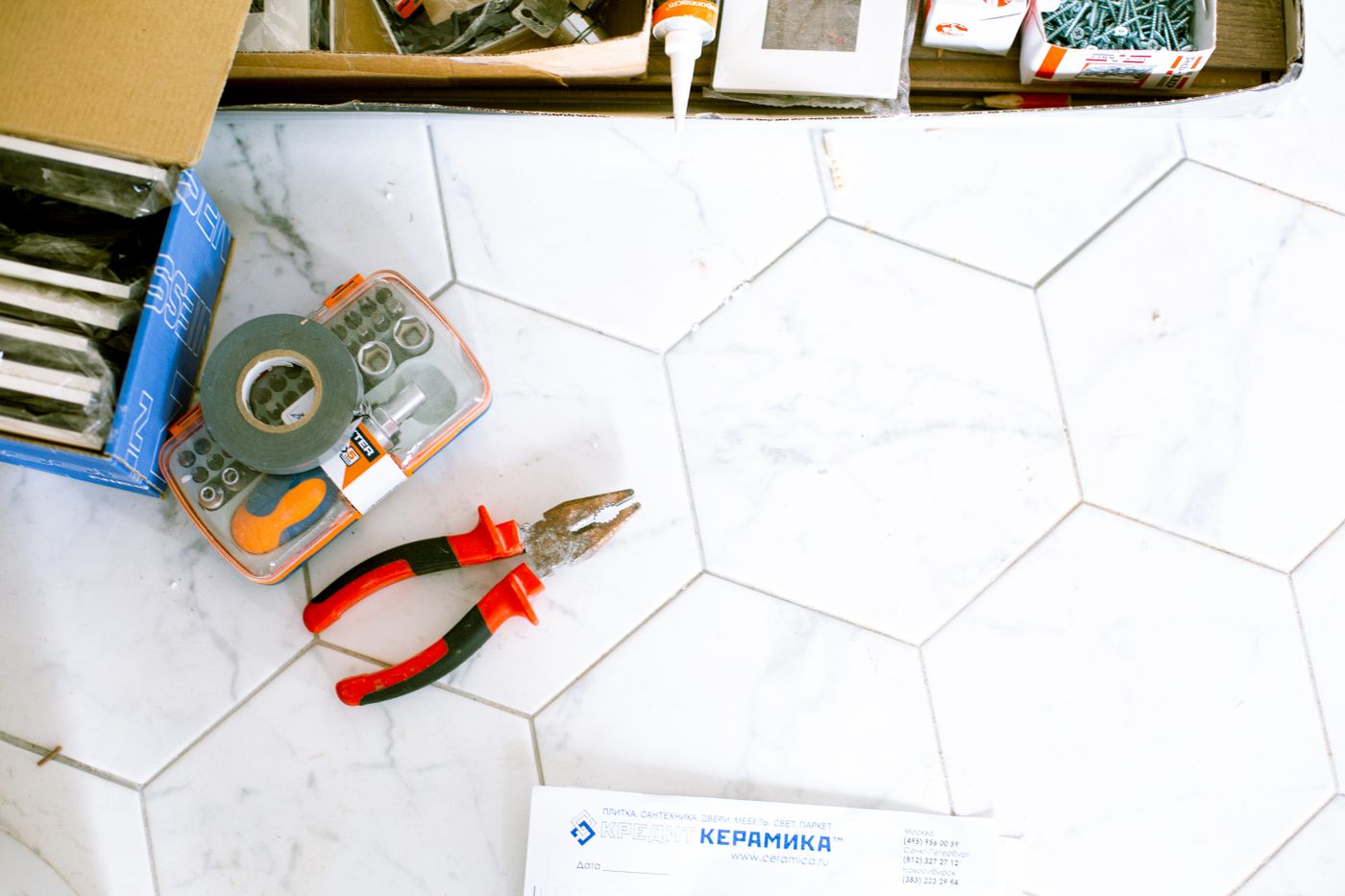 Representative stock photo of renovation tools and tiling supplies on a floor